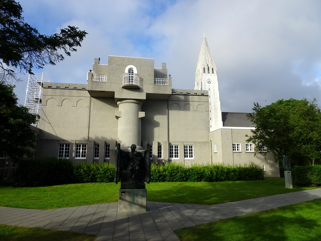 Sculpture `Protection` at the Einar Jónsson Sculpture Garden, the back side of the Einar Jónsson Museum and the tower of the Hallgrímskirkja church