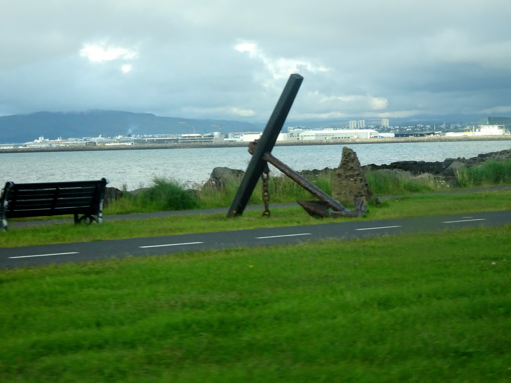 Large anchor at the Göngustígur path along the shore, viewed from the rental car on the Norðurströnd street