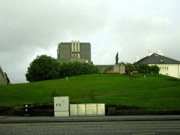 The Arnarhóll park with the statue of Ingólfur Arnarson, the National Theatre of Iceland and the Culture House museum, viewed from the rental car on the Geirsgata street