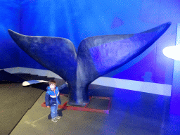 Max with a statue of a Whale`s tail at the Whales of Iceland exhibition