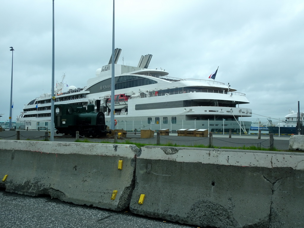 Locomotive and large ship in the Reykjavik Harbour, viewed from the rental car on the Geirsgata street