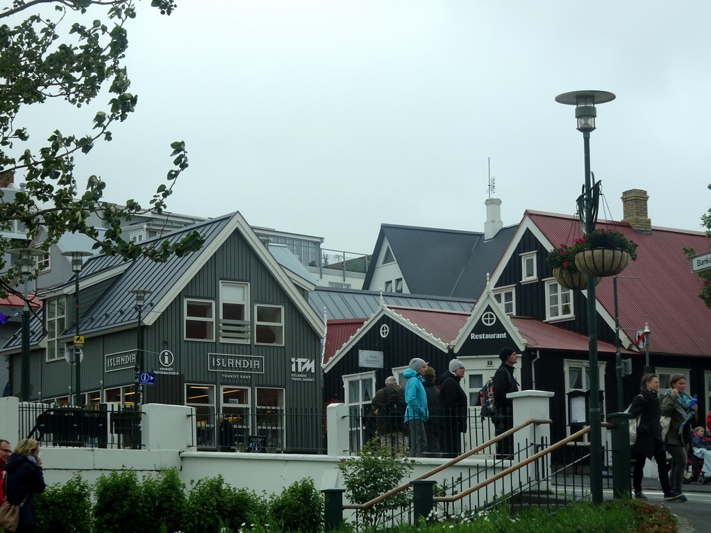 The Islandia Tourist Shop and the Lækjarbrekka restaurant at the Bankastræti street, viewed from the rental car on the Lækjargata street