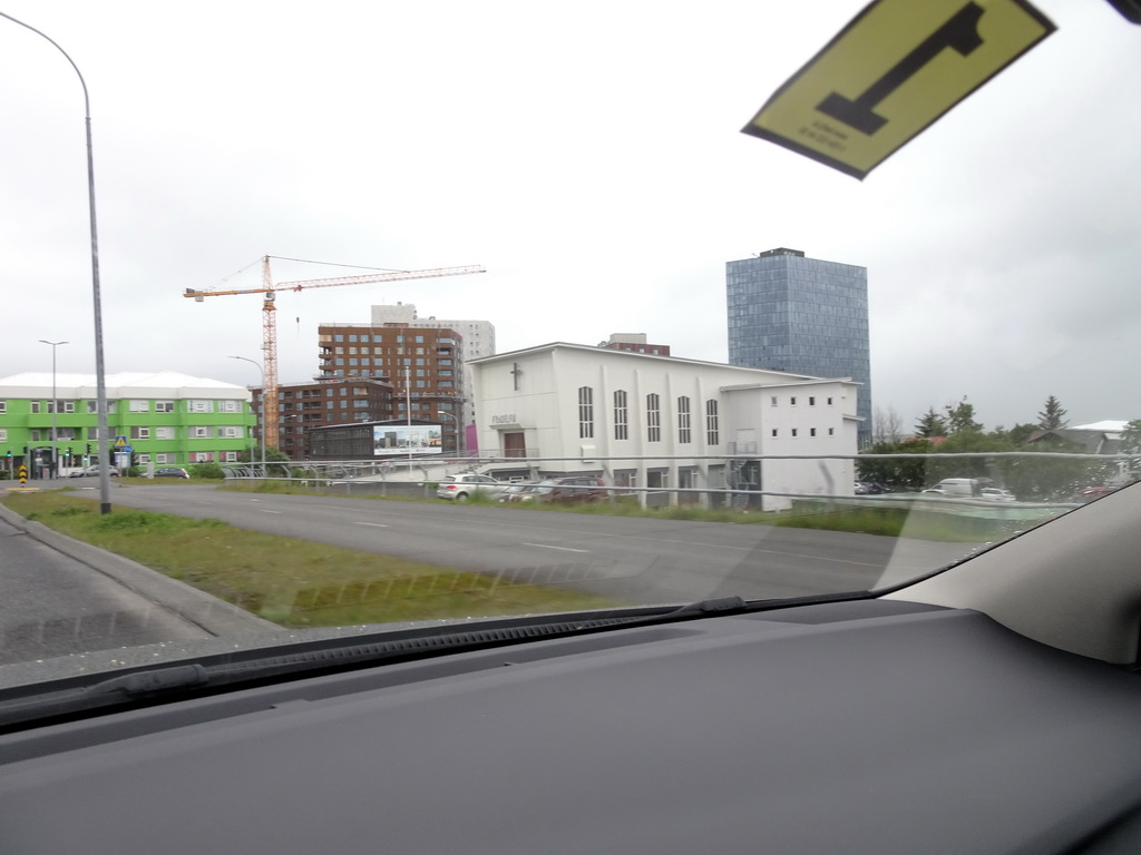 The Laugavegur street with the Hvítasunnukirkjan Fíladelfía church and the Höfðatorg business center, viewed from the rental car