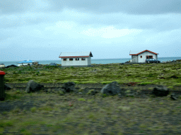 Houses west of Hafnarfjörður, viewed from the rental car on the Reykjanesbraut road
