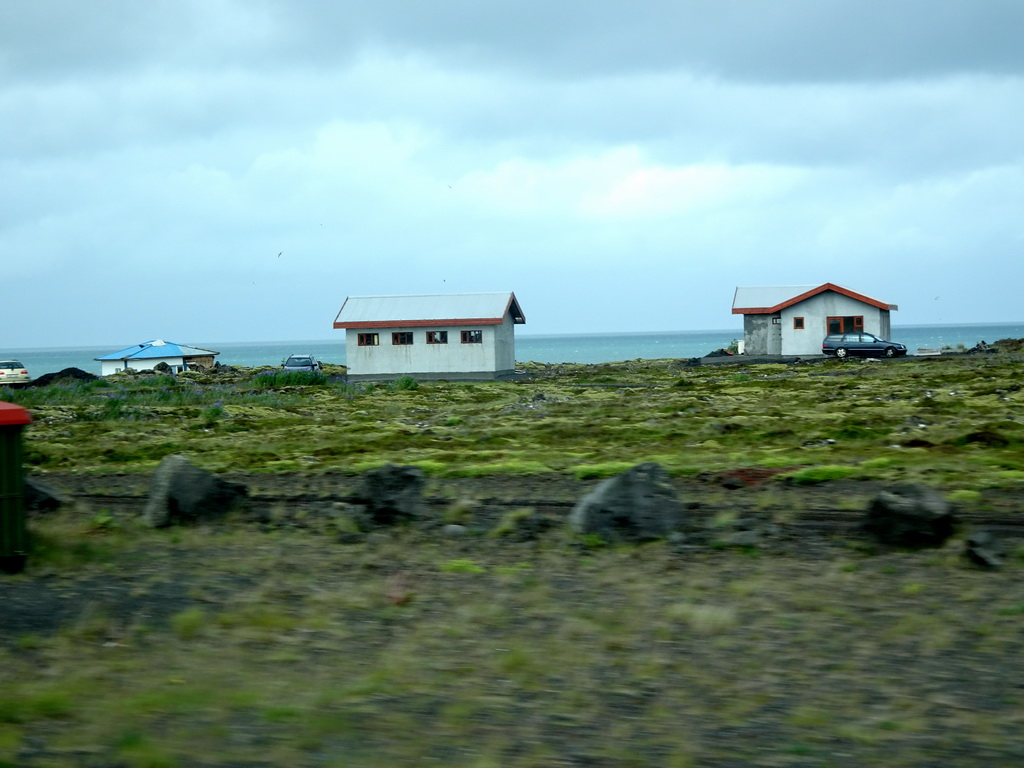 Houses west of Hafnarfjörður, viewed from the rental car on the Reykjanesbraut road