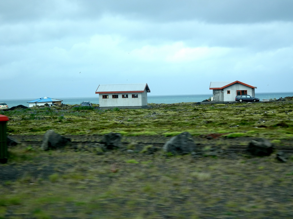 Houses west of Hafnarfjörður, viewed from the rental car on the Reykjanesbraut road
