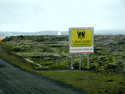 Sign of the `Town of Vikings` of Hafnarfjörður, viewed from the rental car on the Reykjanesbraut road