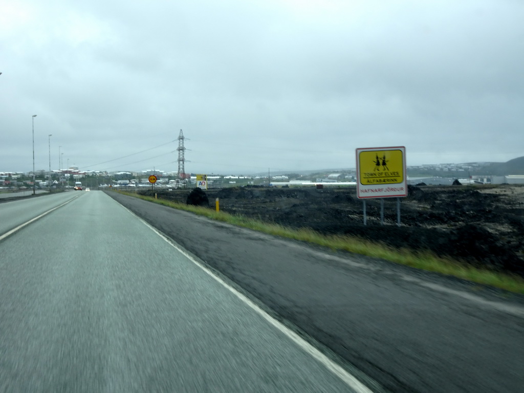 Sign of the `Town of Elves` of Hafnarfjörður, viewed from the rental car on the Reykjanesbraut road