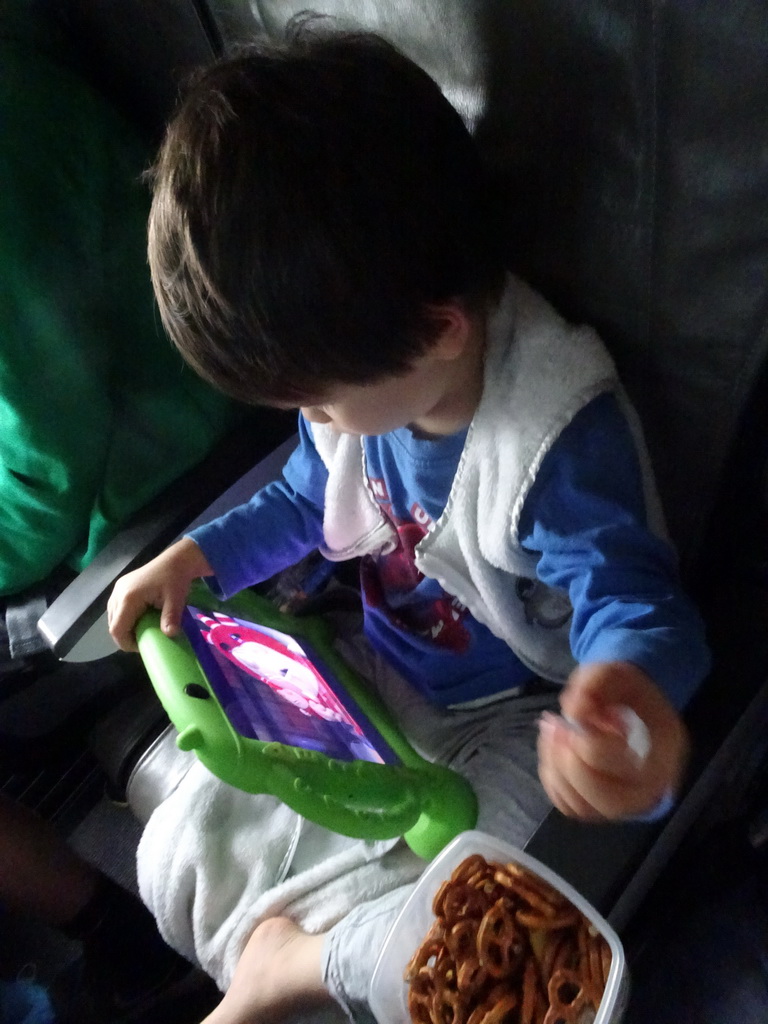 Max watching iPad in the airplane to Munich