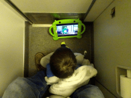 Max watching iPad in the airplane to Munich