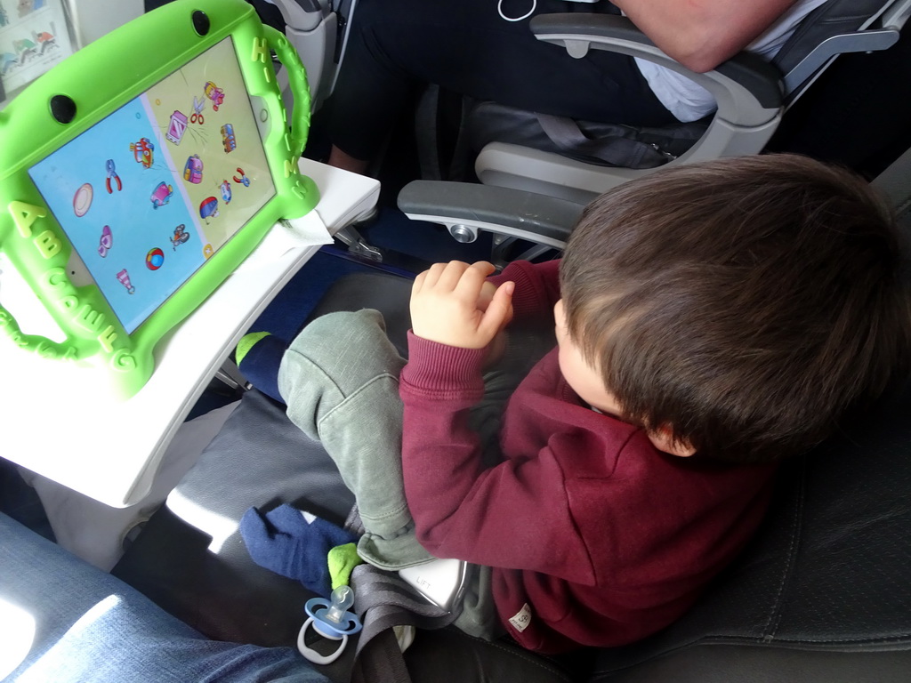 Max watching iPad in the airplane from Munich to Amsterdam