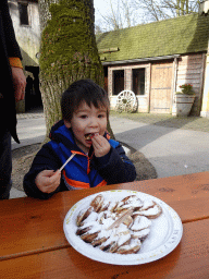 Max eating Poffertjes at the Poffertjes Restaurant at the Karpatica village at the Ouwehands Dierenpark zoo