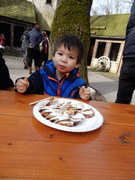 Max eating Poffertjes at the Poffertjes Restaurant at the Karpatica village at the Ouwehands Dierenpark zoo