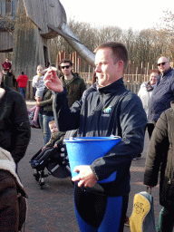 Zookeeper with fish for the Humboldt Penguins at the Ouwehands Dierenpark zoo