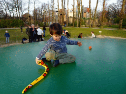 Max with a toy snake and a toy clownfish on the trampoline at the Ouwehands Dierenpark zoo