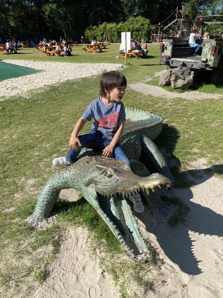 Max on a crocodile statue at the Ouwehands Dierenpark zoo