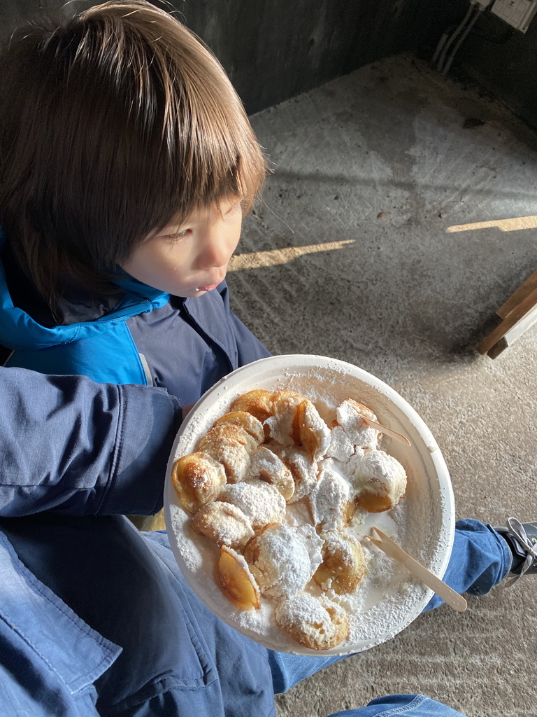 Max eating Poffertjes at the Poffertjes Restaurant at the Karpatica village at the Ouwehands Dierenpark zoo