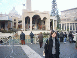 Miaomiao at Saint Peter`s Square, with St. Peter`s Basilica, a christmas tree and the Nativity of Jesus