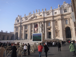 The facade of St. Peter`s Basilica, with the Pope`s Window, the Statue of St. Paul and a big television screen