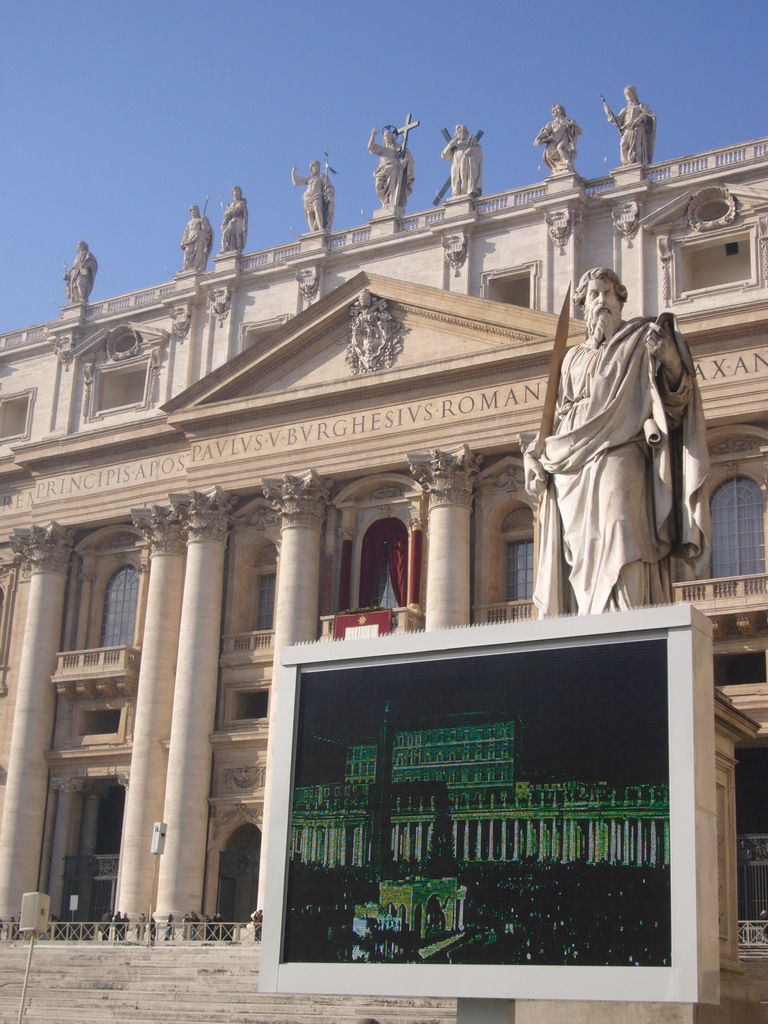 The facade of St. Peter`s Basilica, with the Pope`s Window, the Statue of St. Paul and a big television screen