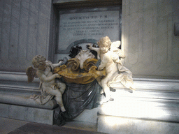 Statues of Cupidos offering holy water, at the foot of the Monument of Pope Benedict XIII, inside St. Peter`s Basilica