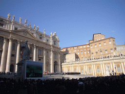 The facade of St. Peter`s Basilica, with the Statue of St. Peter and a big television screen, right before the Christmas celebrations