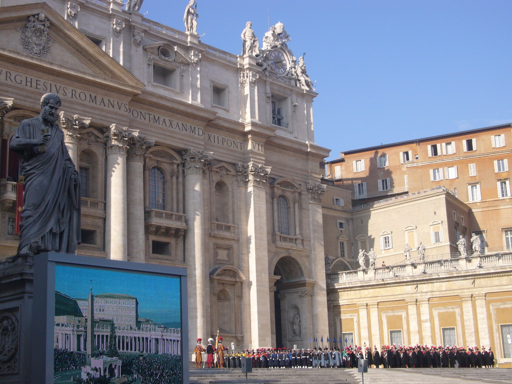 The facade of St. Peter`s Basilica, with the Statue of St. Peter and a big television screen, right before the Christmas celebrations