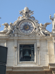 Clock and bell at the facade of St. Peter`s Basilica