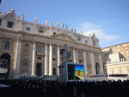 The facade of St. Peter`s Basilica, with the Statue of St. Peter and a big television screen, right before the Christmas celebrations