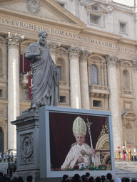 The facade of St. Peter`s Basilica, with Pope Benedict XVI, the statue of St. Peter and a big television screen, during the Christmas celebrations