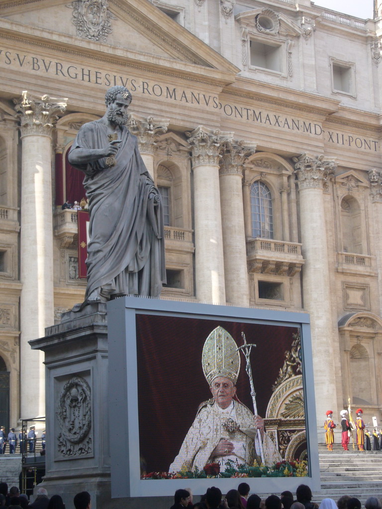 The facade of St. Peter`s Basilica, with Pope Benedict XVI, the statue of St. Peter and a big television screen, during the Christmas celebrations