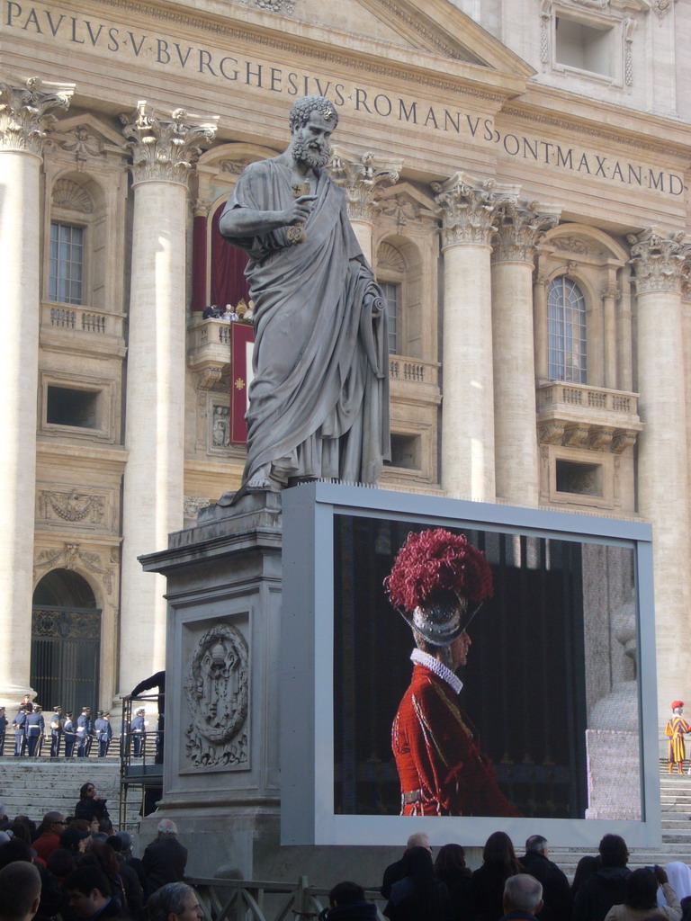 The facade of St. Peter`s Basilica, with Pope Benedict XVI, the statue of St. Peter and a big television screen, during the Christmas celebrations