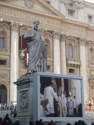 The facade of St. Peter`s Basilica, with Pope Benedict XVI, the statue of St. Peter and a big television screen, during the Christmas celebrations