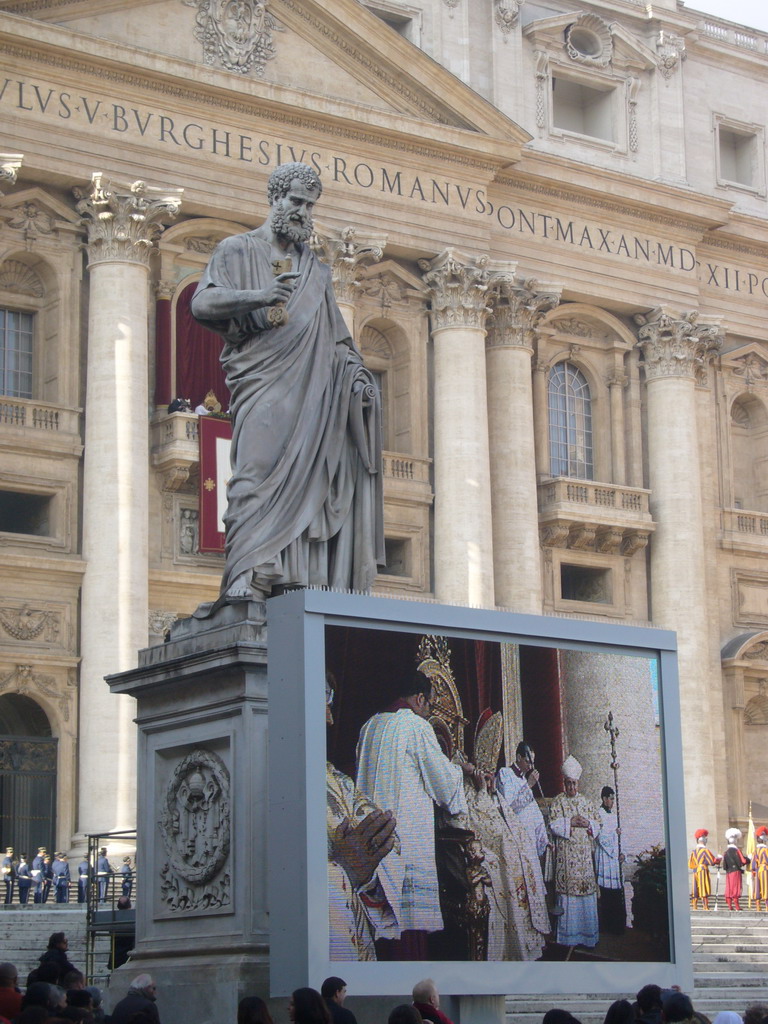 The facade of St. Peter`s Basilica, with Pope Benedict XVI, the statue of St. Peter and a big television screen, during the Christmas celebrations