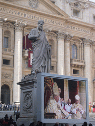 The facade of St. Peter`s Basilica, with Pope Benedict XVI, the statue of St. Peter and a big television screen, during the Christmas celebrations