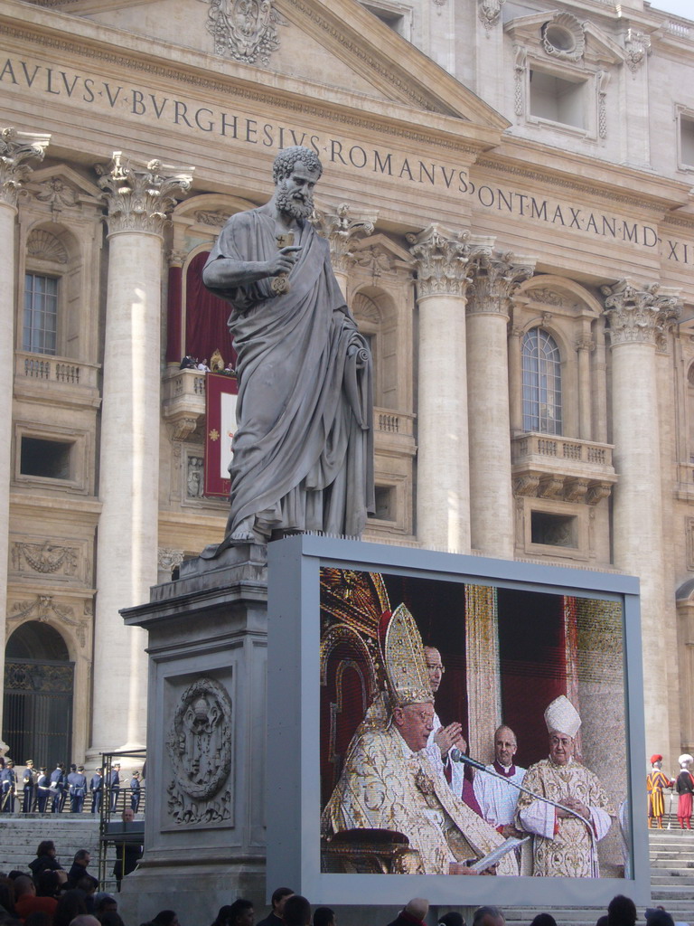 The facade of St. Peter`s Basilica, with Pope Benedict XVI, the statue of St. Peter and a big television screen, during the Christmas celebrations