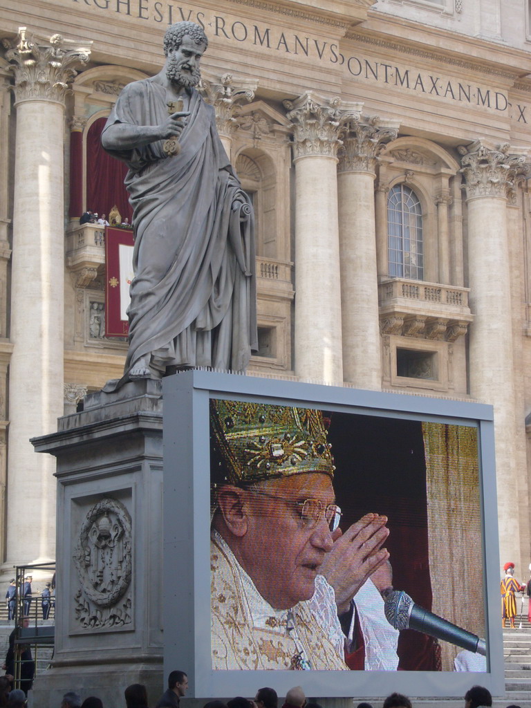 The facade of St. Peter`s Basilica, with Pope Benedict XVI, the statue of St. Peter and a big television screen, during the Christmas celebrations