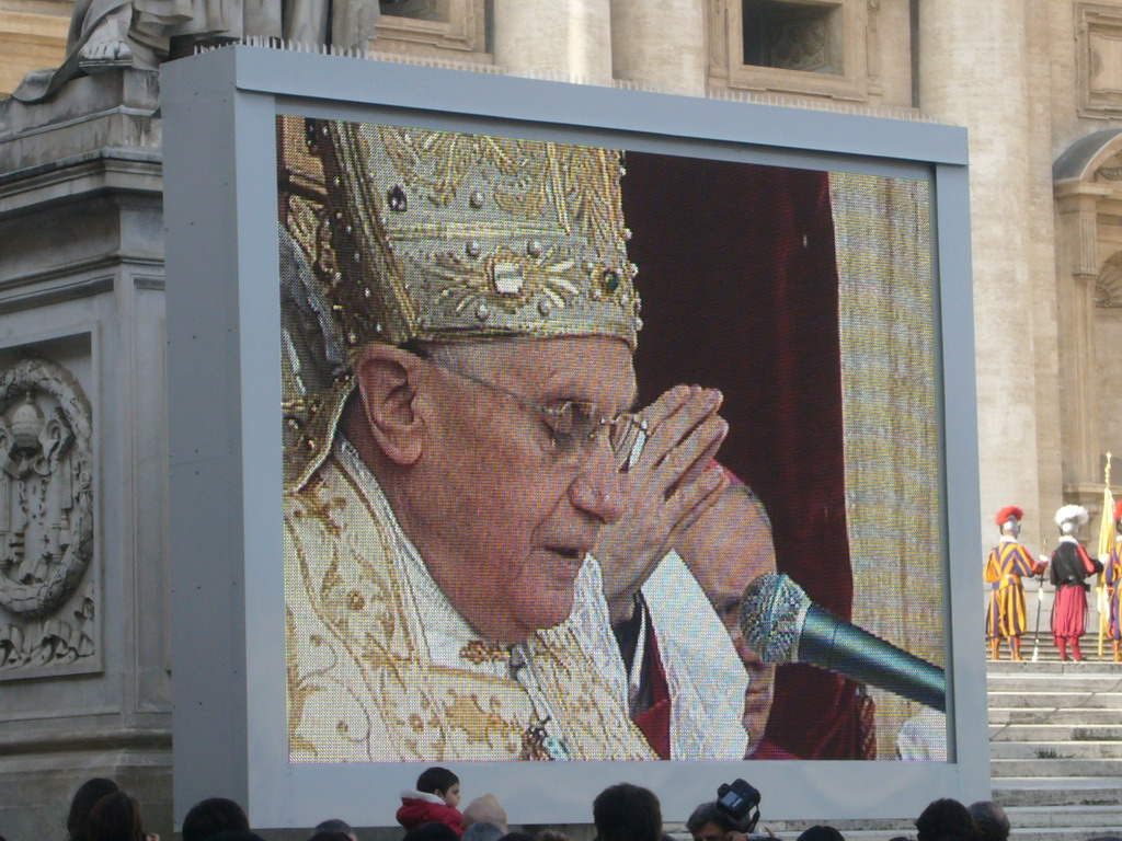 The facade of St. Peter`s Basilica, with Pope Benedict XVI, the statue of St. Peter and a big television screen, during the Christmas celebrations