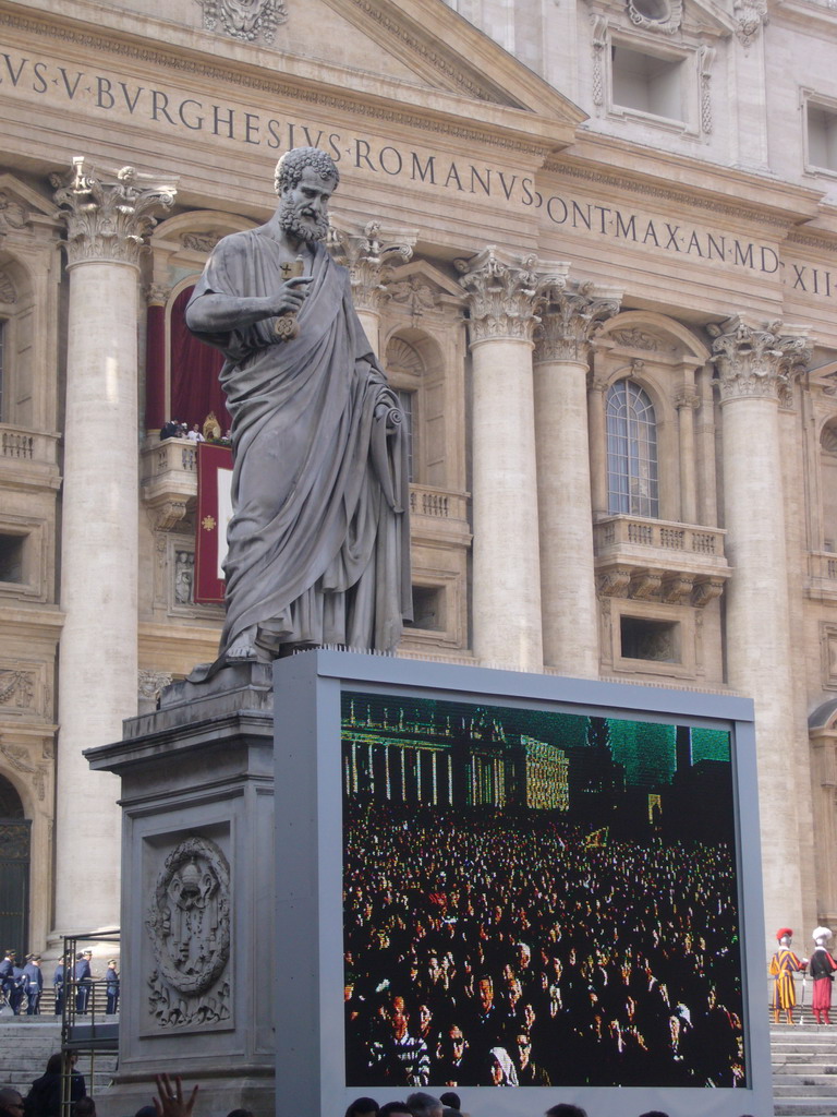 The facade of St. Peter`s Basilica, with Pope Benedict XVI, the statue of St. Peter and a big television screen, during the Christmas celebrations