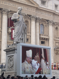 The facade of St. Peter`s Basilica, with Pope Benedict XVI, the statue of St. Peter and a big television screen, during the Christmas celebrations