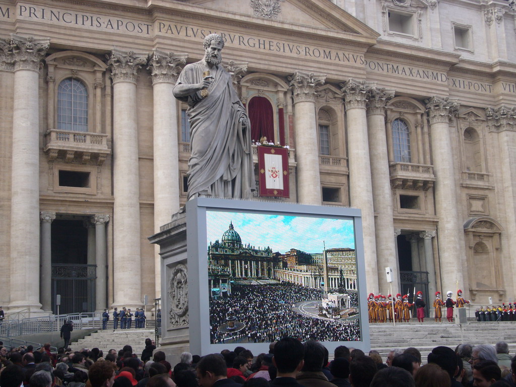 The facade of St. Peter`s Basilica, with Pope Benedict XVI, the statue of St. Peter and a big television screen, during the Christmas celebrations