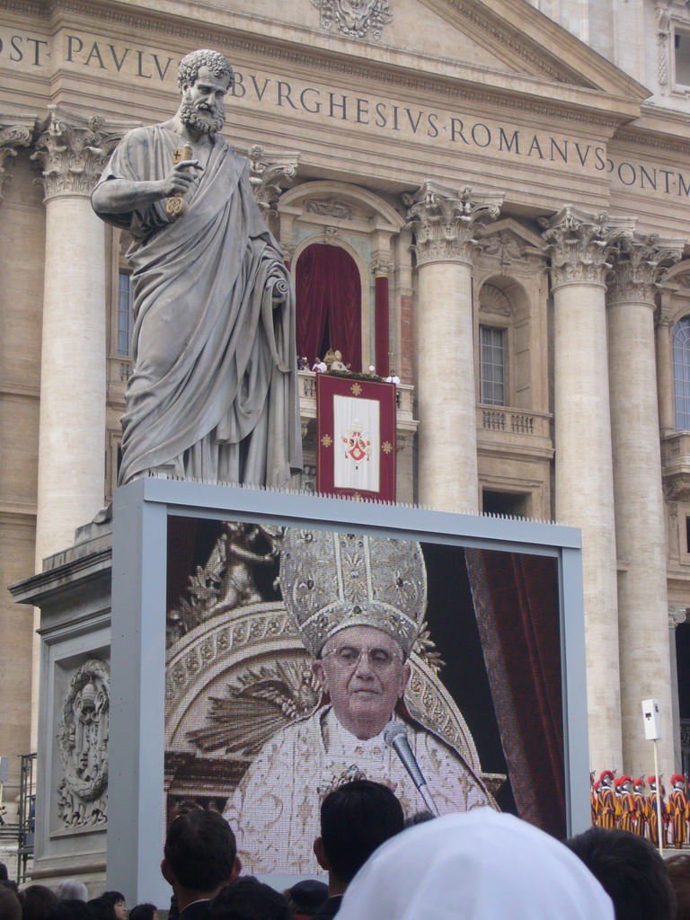 The facade of St. Peter`s Basilica, with Pope Benedict XVI, the statue of St. Peter and a big television screen, during the Christmas celebrations