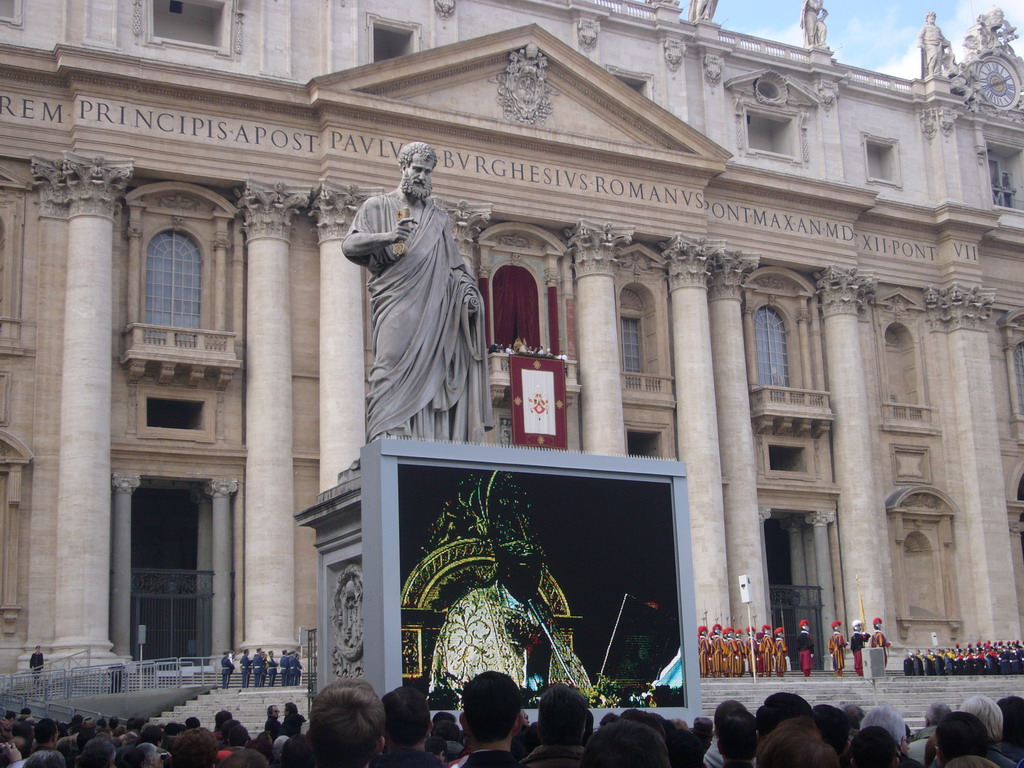 The facade of St. Peter`s Basilica, with Pope Benedict XVI, the statue of St. Peter and a big television screen, during the Christmas celebrations