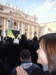 Miaomiao and the facade of St. Peter`s Basilica, with Pope Benedict XVI, the statue of St. Peter and a big television screen, during the Christmas celebrations