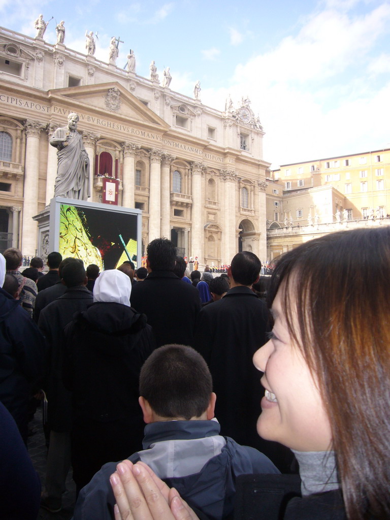 Miaomiao and the facade of St. Peter`s Basilica, with Pope Benedict XVI, the statue of St. Peter and a big television screen, during the Christmas celebrations