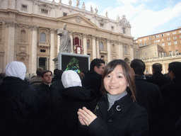 Miaomiao and the facade of St. Peter`s Basilica, with Pope Benedict XVI, the statue of St. Peter and a big television screen, during the Christmas celebrations