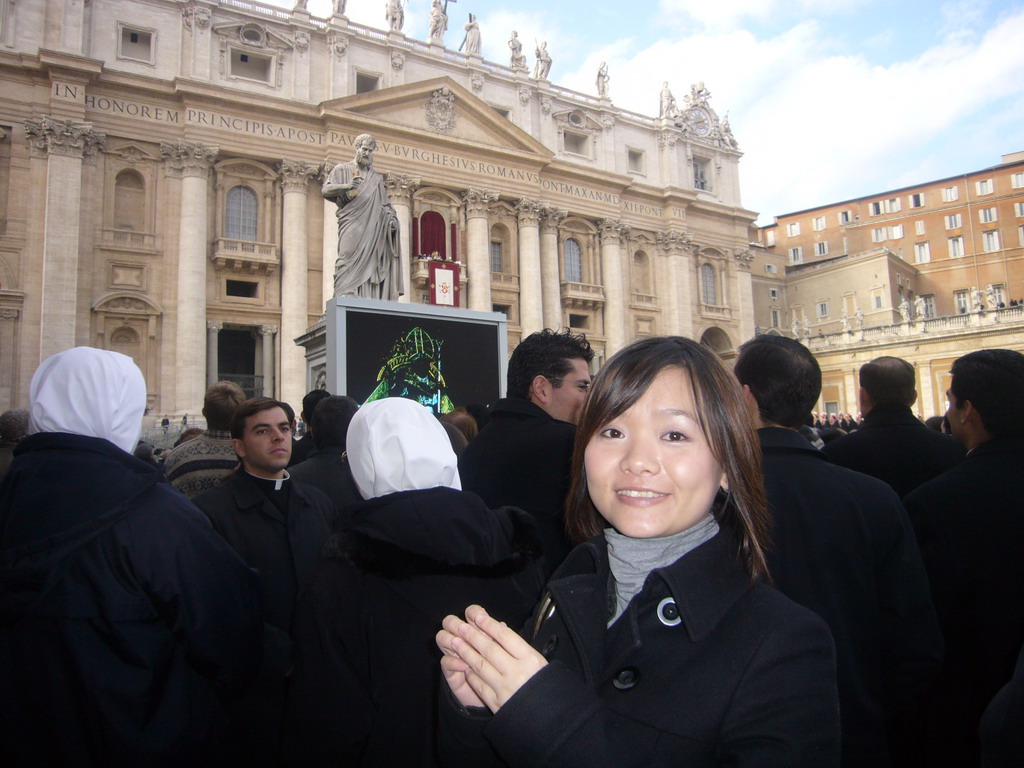 Miaomiao and the facade of St. Peter`s Basilica, with Pope Benedict XVI, the statue of St. Peter and a big television screen, during the Christmas celebrations
