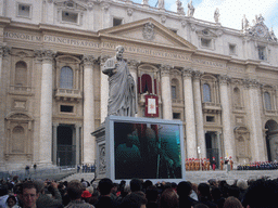 The facade of St. Peter`s Basilica, with Pope Benedict XVI, the statue of St. Peter and a big television screen, during the Christmas celebrations