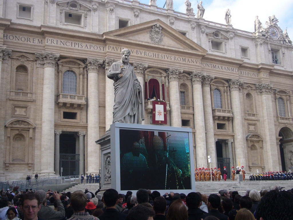 The facade of St. Peter`s Basilica, with Pope Benedict XVI, the statue of St. Peter and a big television screen, during the Christmas celebrations