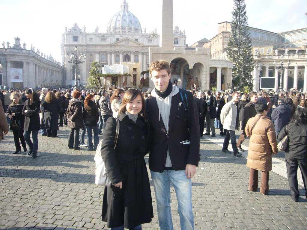 Tim and Miaomiao with the facade of St. Peter`s Basilica, the Vatican Obelisk, a christmas tree and the Nativity of Jesus, at Saint Peter`s Square, right after the Christmas celebrations